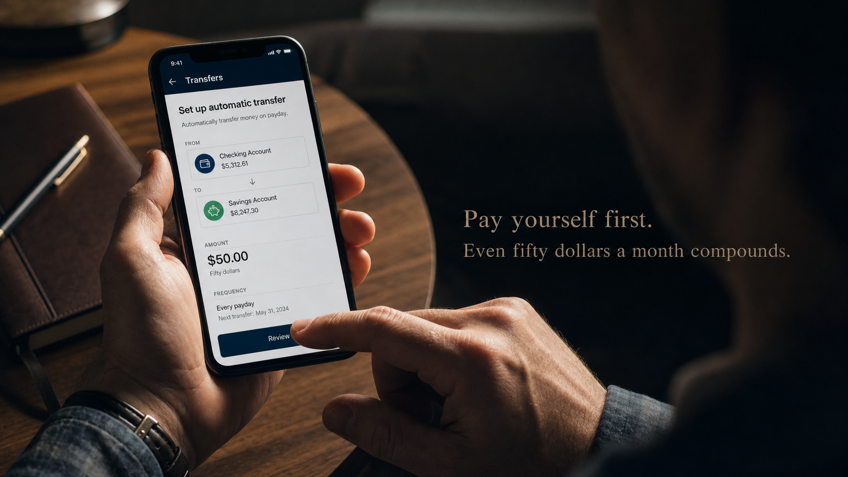 Hands setting up automatic transfer to savings