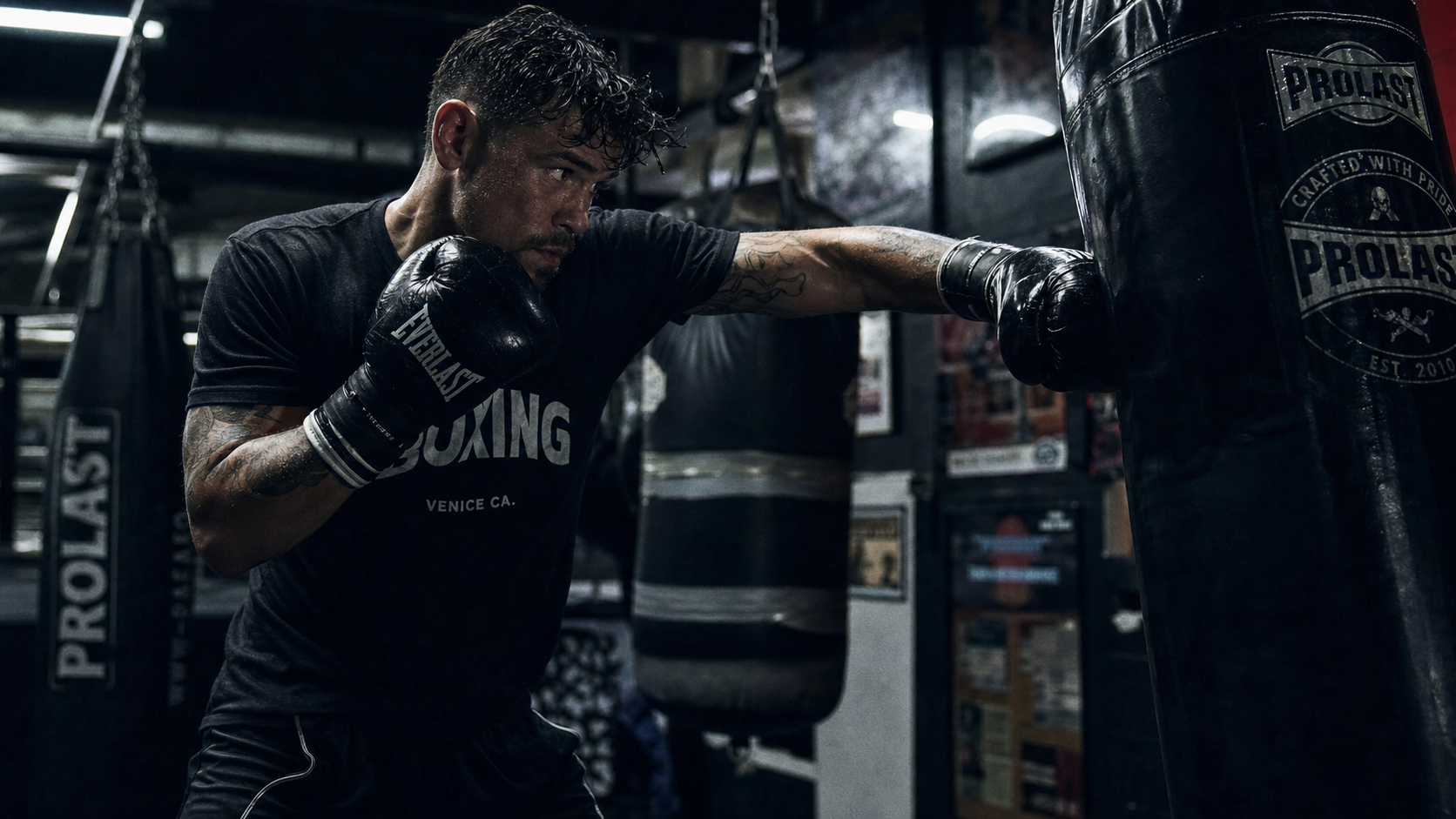 Boxer striking heavy bag in gym