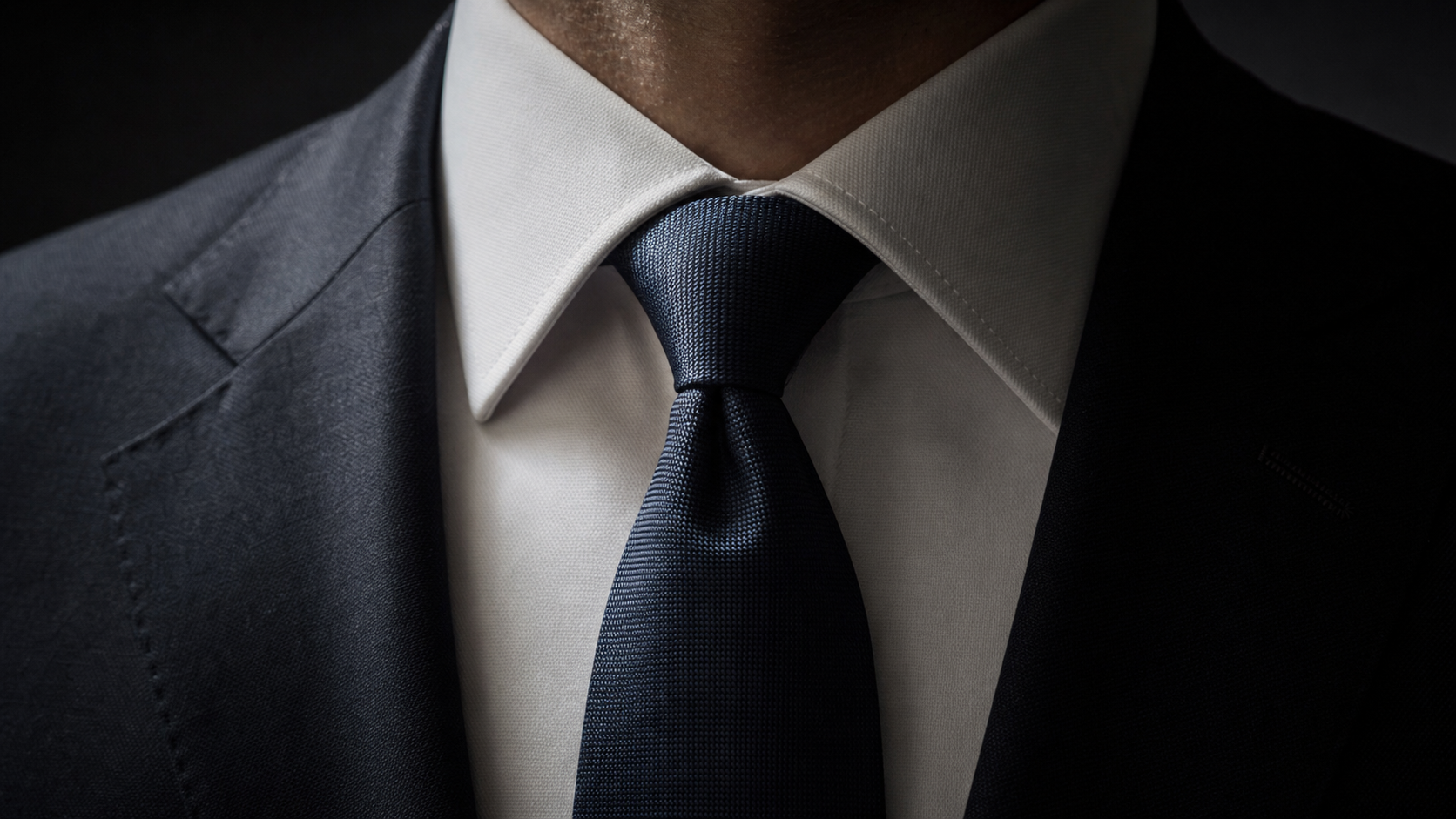 Finished Four-in-Hand knot with clean dimple, suit jacket
